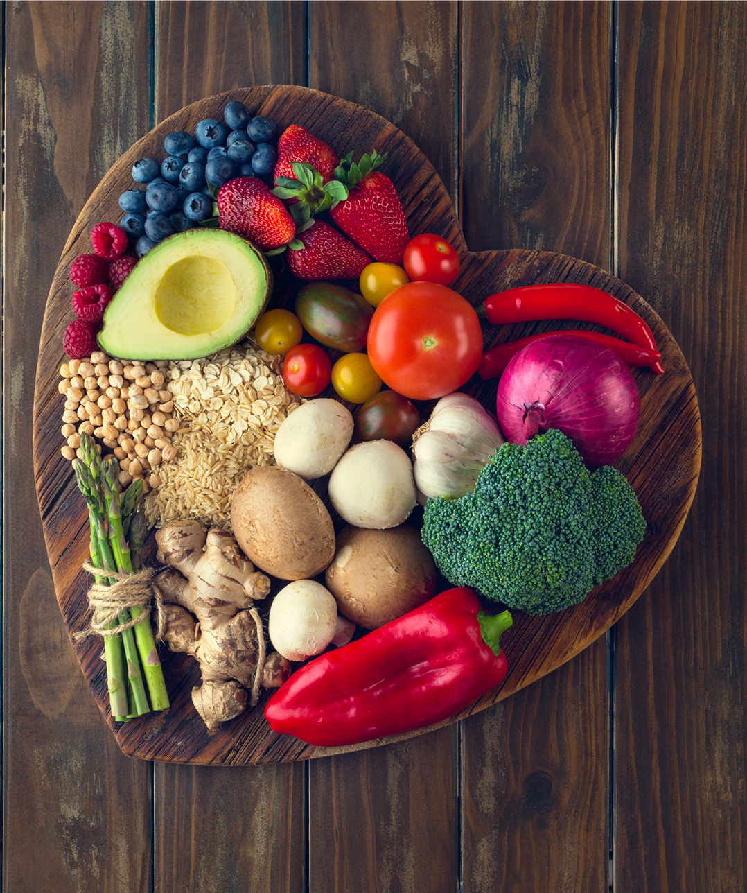 Heart-shaped board with assorted fresh produce.
